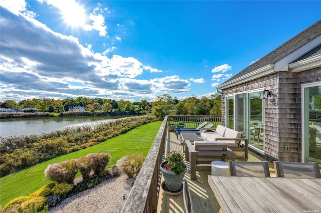 exterior space featuring a deck with water view