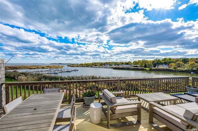 wooden terrace featuring a water view