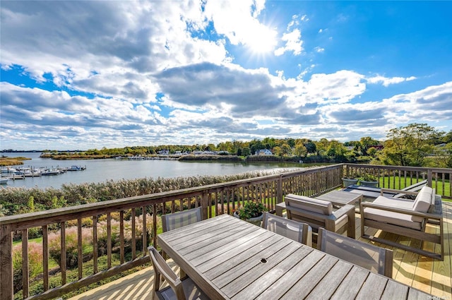 wooden terrace featuring a water view