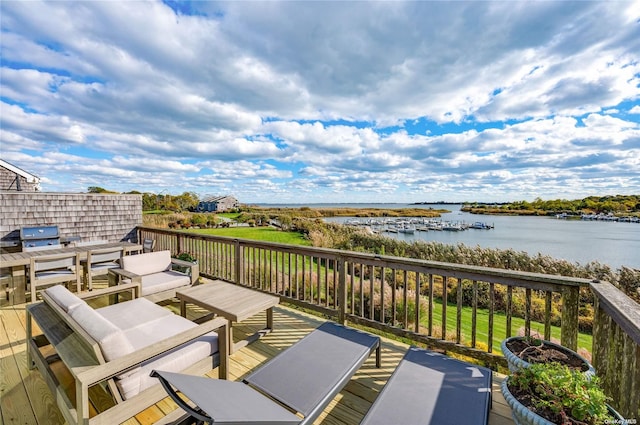 wooden terrace featuring a water view and an outdoor hangout area