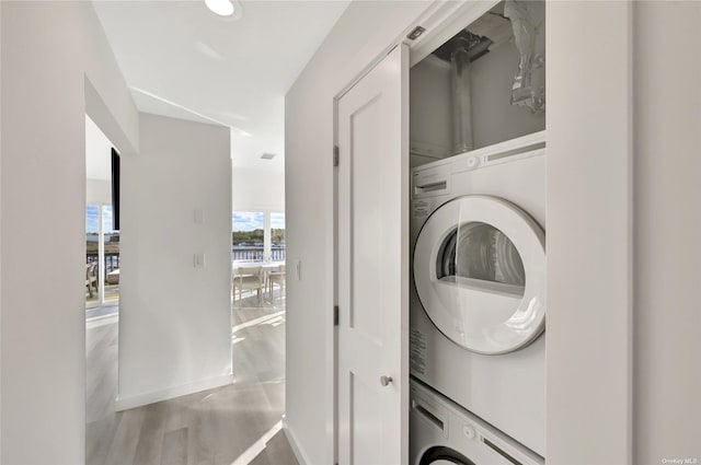 clothes washing area featuring stacked washer and dryer