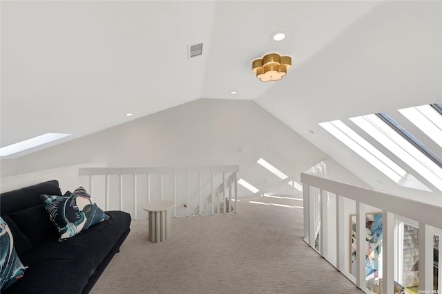 additional living space with light colored carpet and lofted ceiling with skylight