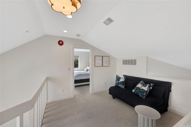 living area featuring light colored carpet and vaulted ceiling