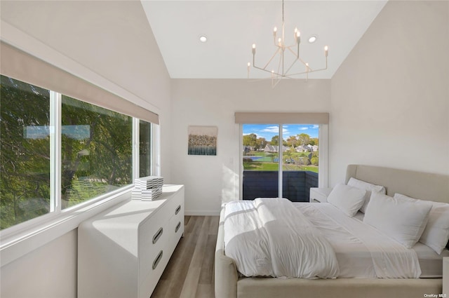 bedroom featuring dark wood-type flooring, multiple windows, access to outside, and vaulted ceiling