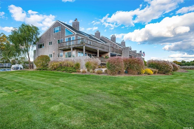 back of house with a lawn