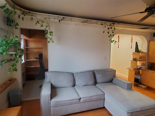 living room featuring light hardwood / wood-style floors and ceiling fan