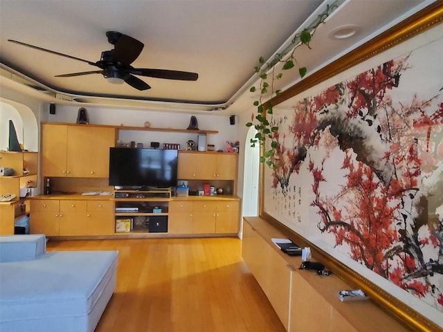 living room with ceiling fan and light hardwood / wood-style floors