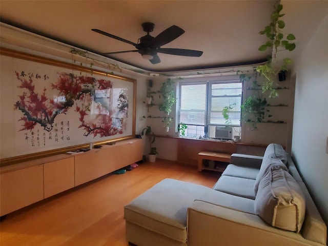 home theater featuring cooling unit, light hardwood / wood-style floors, and ceiling fan