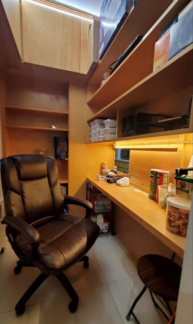 office space with built in desk and tile patterned floors