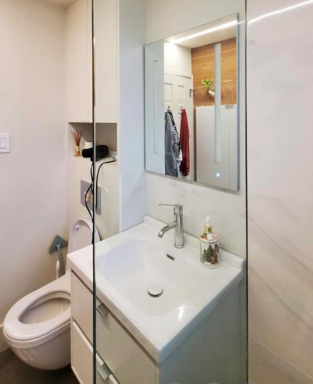 bathroom featuring vanity and toilet