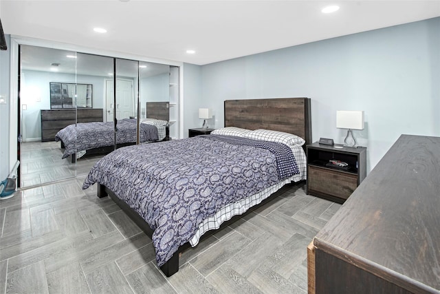 bedroom featuring parquet floors and a closet