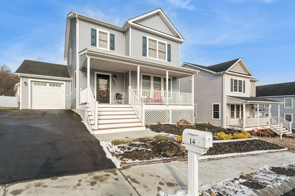 view of front of property with covered porch and a garage