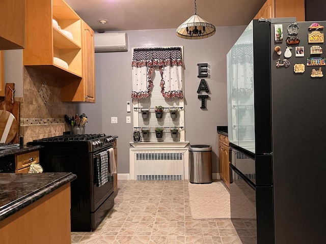 kitchen with an AC wall unit, radiator heating unit, black appliances, decorative light fixtures, and tasteful backsplash