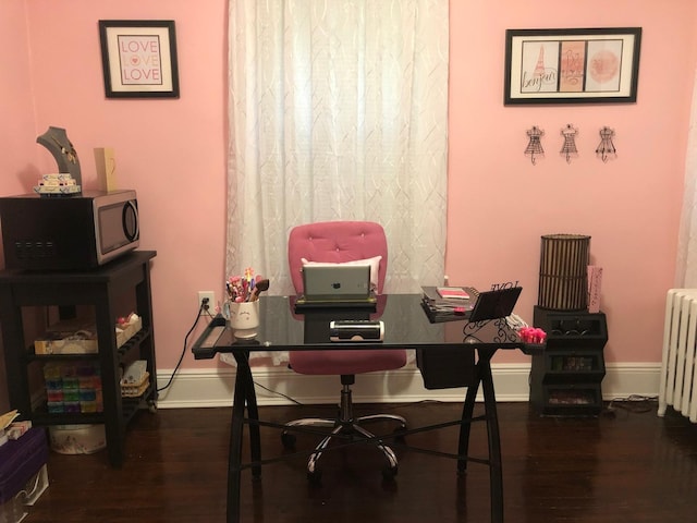 office with dark hardwood / wood-style flooring and radiator