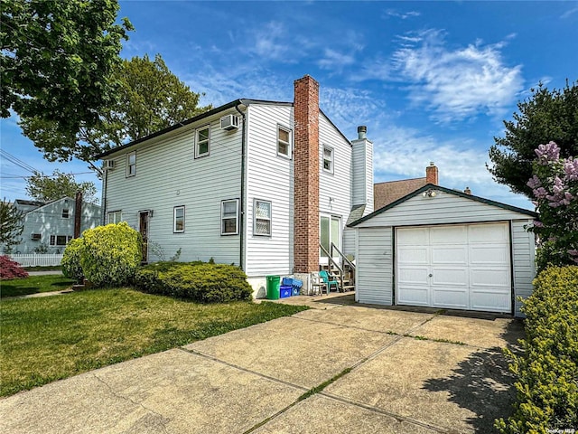 view of side of property featuring a garage, a wall unit AC, an outbuilding, and a lawn