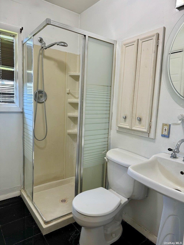 bathroom featuring toilet and walk in shower