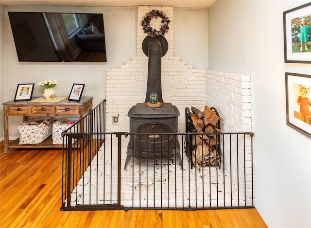 room details featuring a wood stove and hardwood / wood-style floors