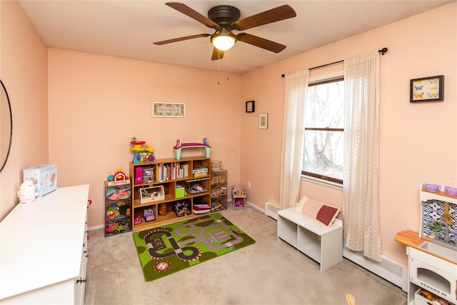 rec room with carpet, ceiling fan, and a baseboard radiator