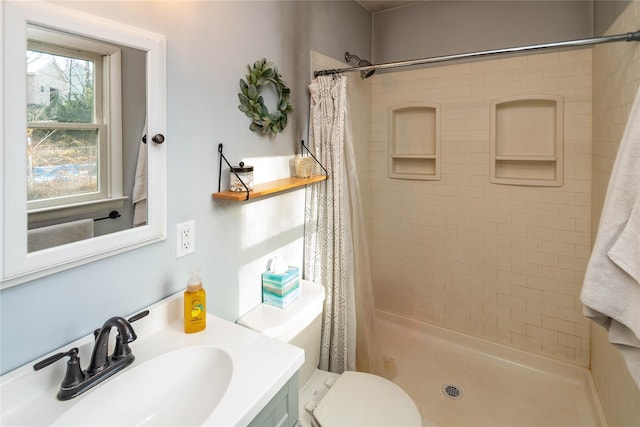 bathroom with toilet, a shower with curtain, and sink