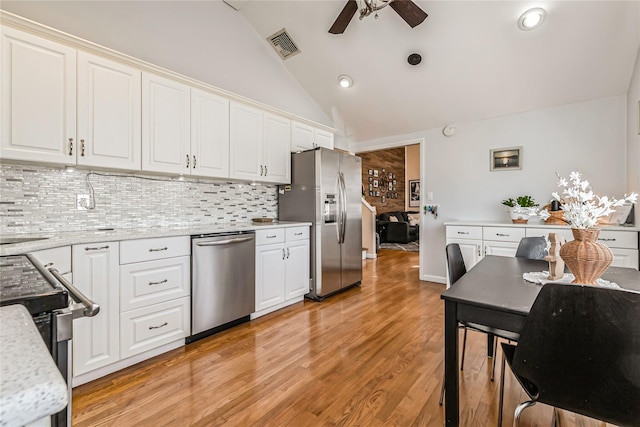 kitchen featuring white cabinets, stainless steel appliances, light wood-style floors, and ceiling fan