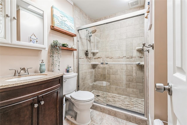 full bathroom featuring visible vents, toilet, a stall shower, tile patterned floors, and vanity