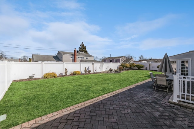 view of yard with a fenced backyard, outdoor dining space, and a patio