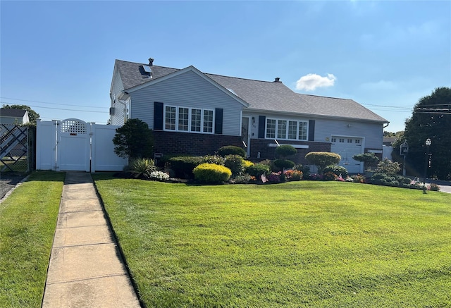 view of front of house featuring brick siding, a shingled roof, a front lawn, and a gate