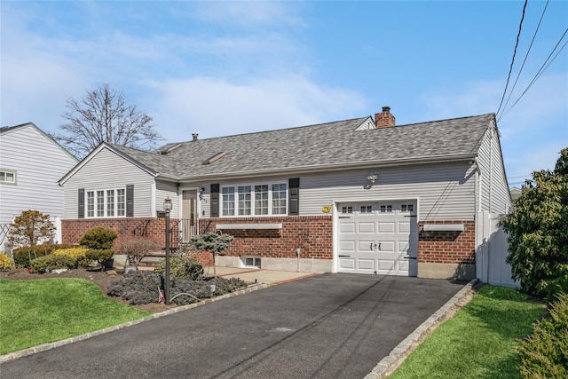 ranch-style house with brick siding, an attached garage, a chimney, and driveway