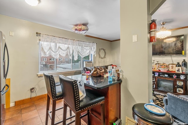 tiled dining space with ornamental molding