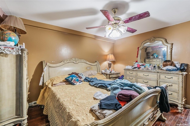 bedroom with ceiling fan and dark wood-type flooring