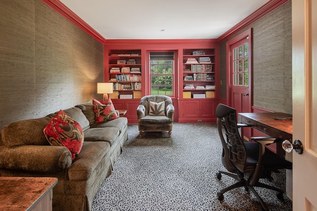 office space with carpet flooring, crown molding, built in shelves, and wallpapered walls