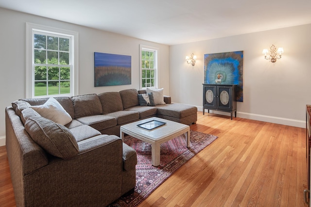 living area with light wood-style floors and baseboards