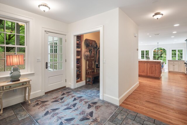 foyer with baseboards, recessed lighting, and light wood finished floors