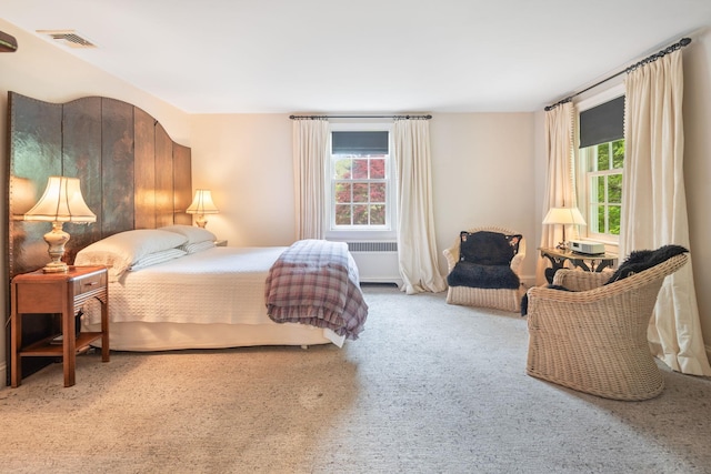 carpeted bedroom with radiator heating unit