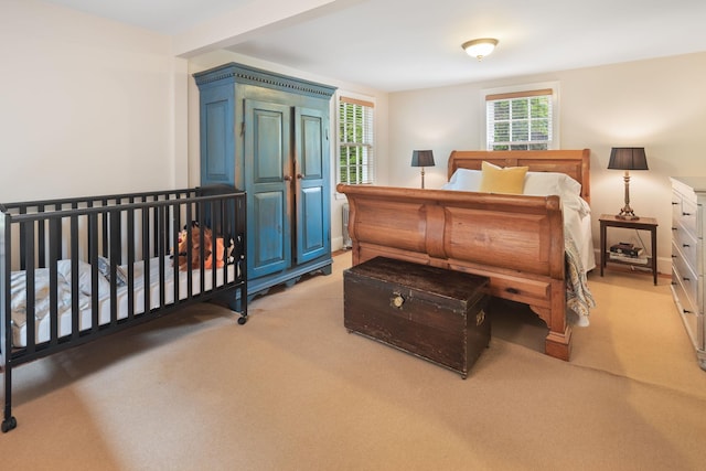 bedroom featuring light colored carpet