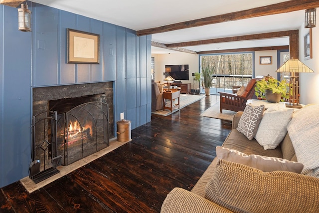 living room with beam ceiling, dark hardwood / wood-style floors, and a high end fireplace