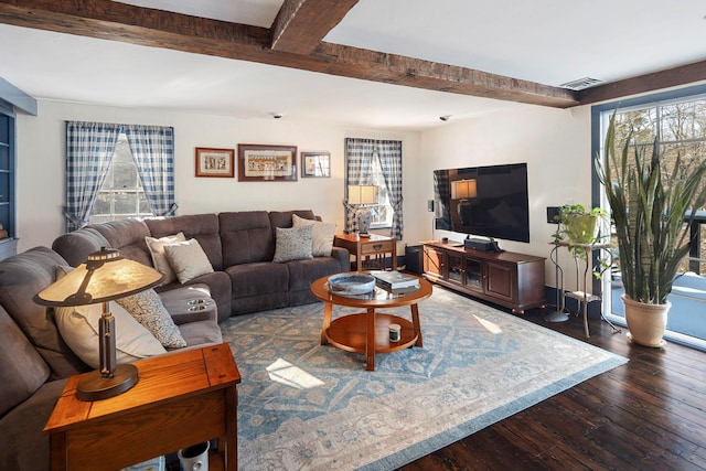 living room with dark wood-type flooring and beamed ceiling