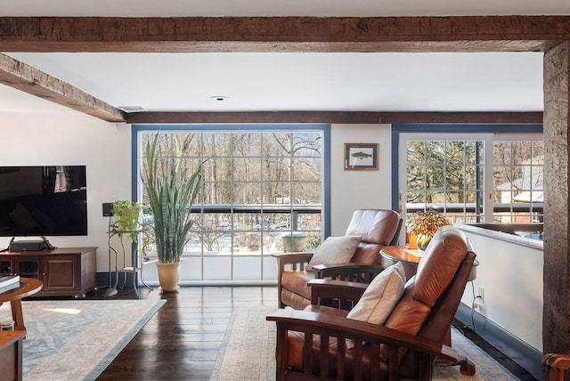 living room with beam ceiling and dark hardwood / wood-style flooring