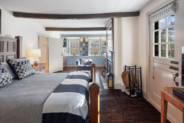 bedroom with multiple windows, dark hardwood / wood-style floors, and beam ceiling