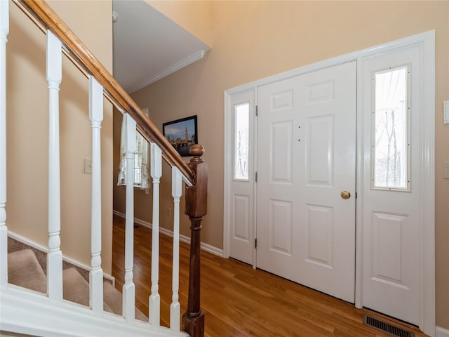 entrance foyer featuring hardwood / wood-style flooring and ornamental molding