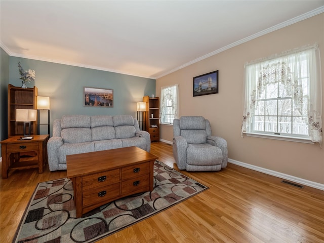 living room with crown molding and light hardwood / wood-style flooring