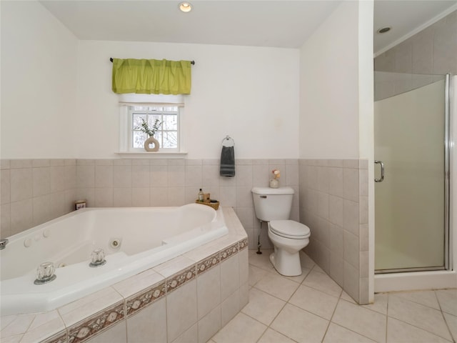 bathroom featuring tile patterned floors, toilet, and separate shower and tub