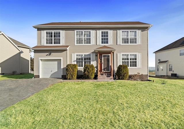 view of front of property featuring a garage and a front lawn