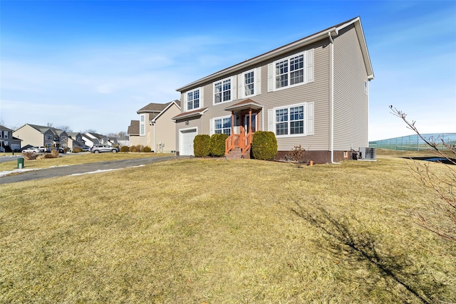 view of front of home with a garage and a front lawn