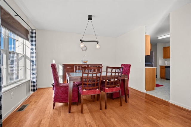 dining space with light hardwood / wood-style floors