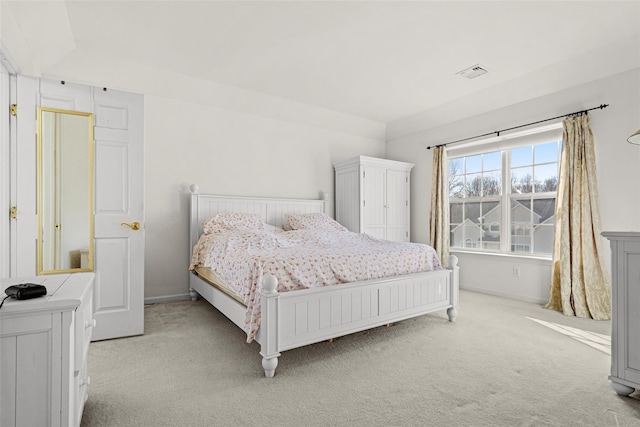 bedroom featuring light colored carpet