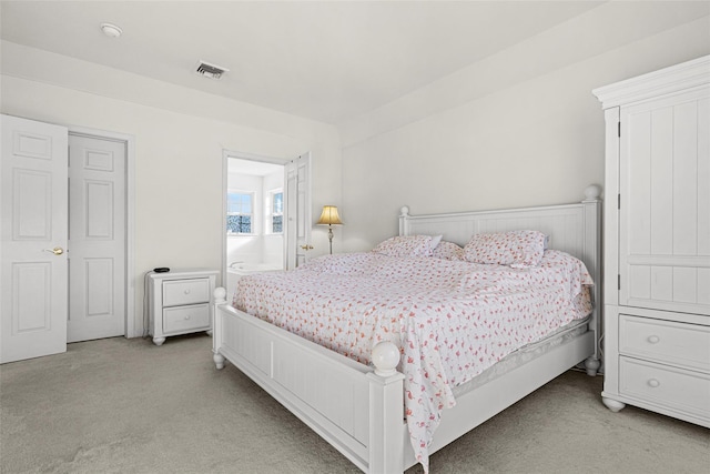 carpeted bedroom featuring ensuite bathroom