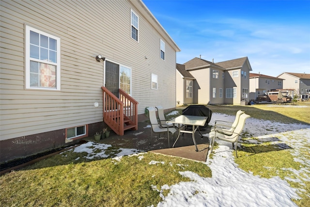 back of property featuring a lawn and a patio