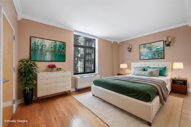 bedroom with crown molding and light wood-type flooring