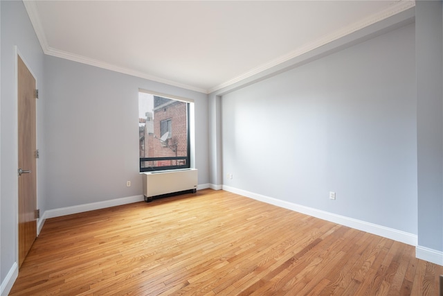 spare room with light hardwood / wood-style floors and ornamental molding